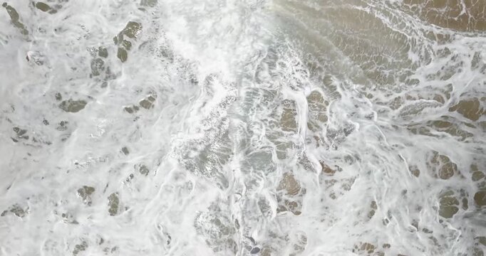 Top down aerial view of ocean waves breaking on tropical beach Panama