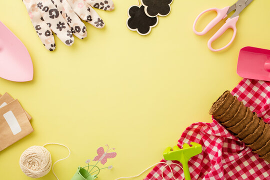 Flat lay on a bright yellow background with gardening equipment