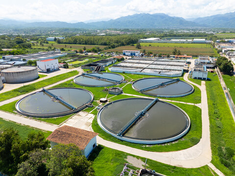 Aerial view of circular water treatment tanks contrasting against the verdant landscape, Puerto Vallarta, Mexico.
