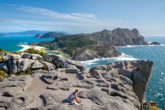 Woman enjoying ocean view from cliffs on Cies Islands, Spain