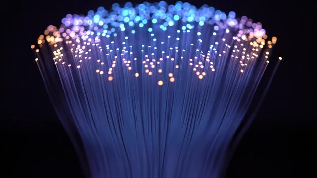 Glowing optic fiber bundle with bokeh effect, isolated on black background