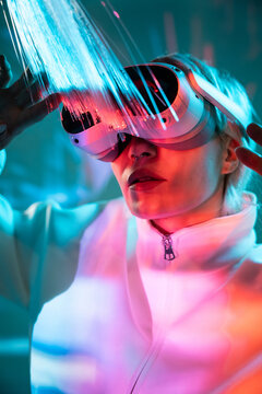 Young woman in the metaverse with fiber optic lights