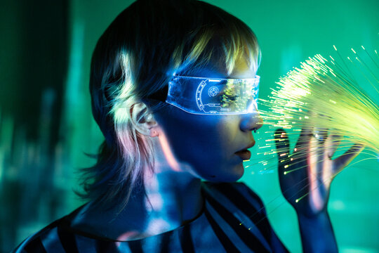 Young woman exploring the metaverse with fiber optics