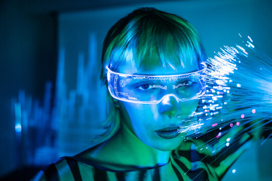 Futuristic young woman with fiber optics and digital glasses