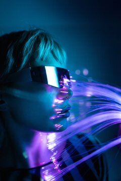 Young woman in futuristic metaverse with fiber optics