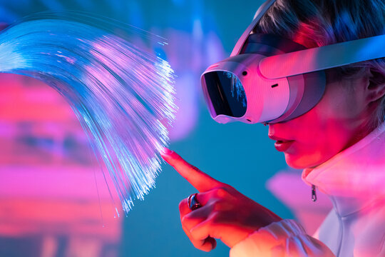 Young woman exploring metaverse with fiber optics