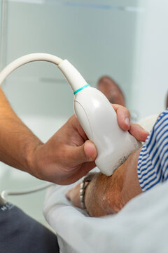 Close-up ultrasound scan on patient arm in clinic setting
