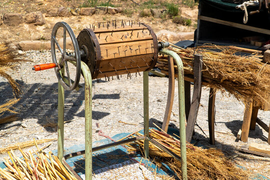 Antique manual grain thresher on rural harvest site