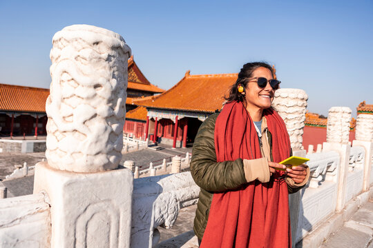 Traveler enjoying audio guide in Beijing's historic site