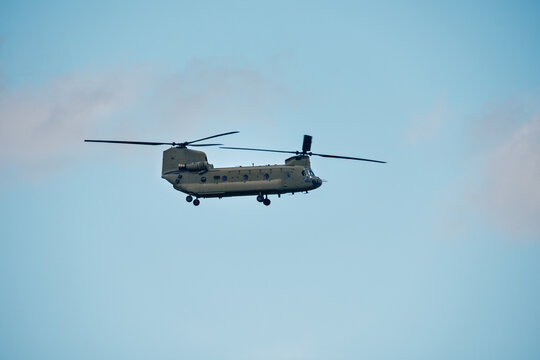 Military transport helicopter flying in clear blue sky
