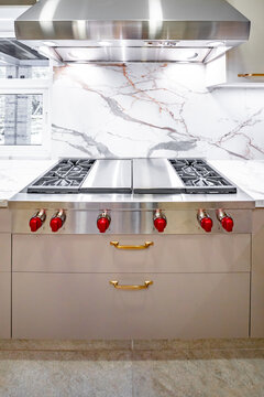 Luxury minimalist kitchen with marble backsplash and range