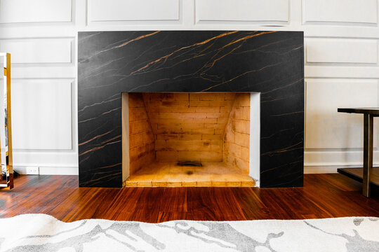Minimalist luxury living room with black marble fireplace