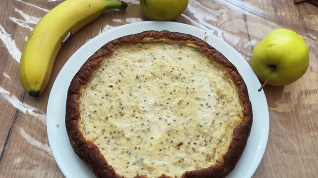 Whole sweet cottage cheese casserole on plate on kitchen table