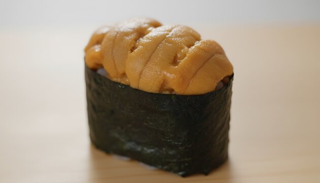 Exquisite gunkan maki sushi topped with vibrant orange sea urchin roe