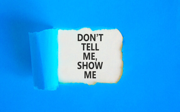 Tell or show symbol. Concept words Do not tell me, show me on beautiful white paper. Beautiful blue paper background. Business tell or show concept. Copy space.