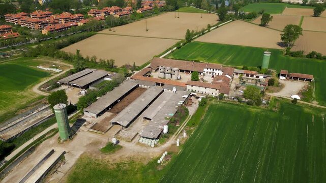 Aerial view of a Farm: An expansive agricultural landscape reveals a meticulously planned farm. The view showcases the synergy between the buildings and the verdant fields.