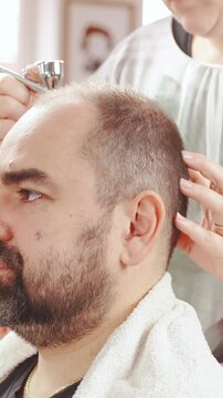 Hair treatment against hair-loss with airbrush in slow motion