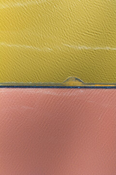 Aerial view of the meeting of vibrant yellow and rose-pink waters, separated by a thin line of deep blue, San Pedro del Pinatar, Region of Murcia, Spain.