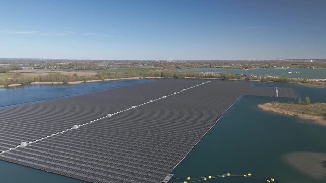 Aerial low altitude orbit of large floating solar farm on a lake