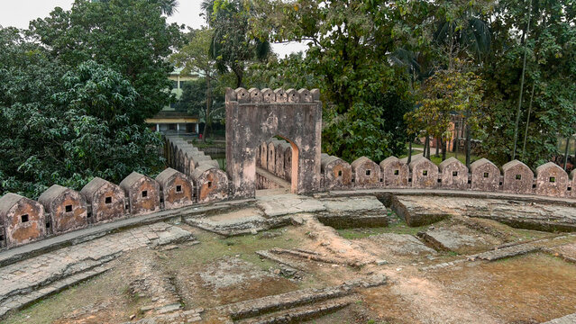 Aerial view of the majestic Idrakpur Fort's weathered walls and arched gateway stand amidst verdant trees, Munshiganj, Dhaka Division, Bangladesh.