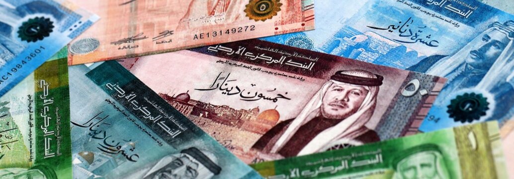 Jordanian dinar money bills pile on table. Jordan banknotes of JOD currency close up.