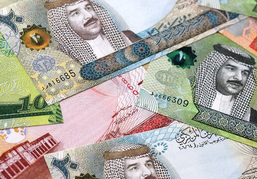 Bahraini dinar money bills pile on table. Bahrain banknotes of BHD currency close up.