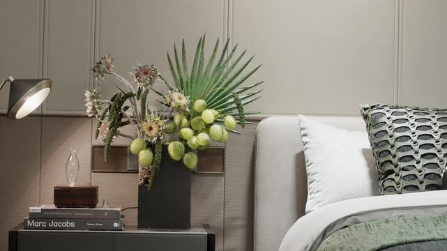 Modern bedroom bedside table with green plant decoration and stylish accessories