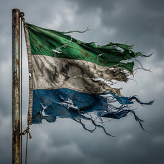 Severely tattered and dirty flag of sierra leone on a weathered flagpole silhouetted against a dramatic and dark stormy sky west africa civil war tattered weathered national struggle hardship © AsmArif