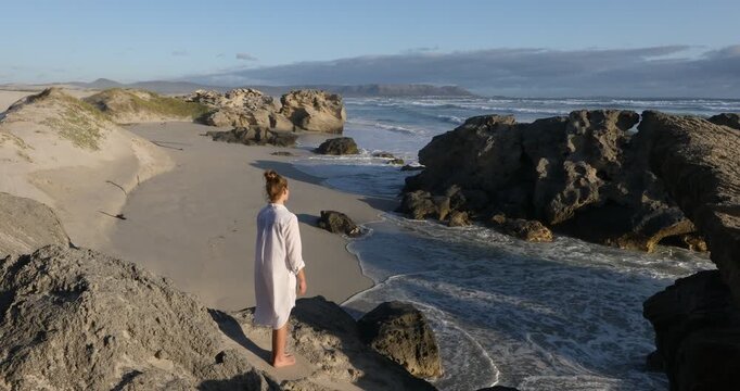 teenage girl overlooking beautiful rocky coastline, Sopies Klip, Hermanus, South Africa
