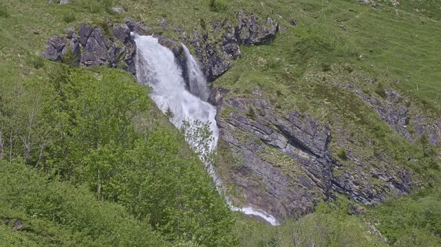 A mountain waterfall with water cascading down from rocky cliffs. Staeuberfall waterfall, Switzerland.