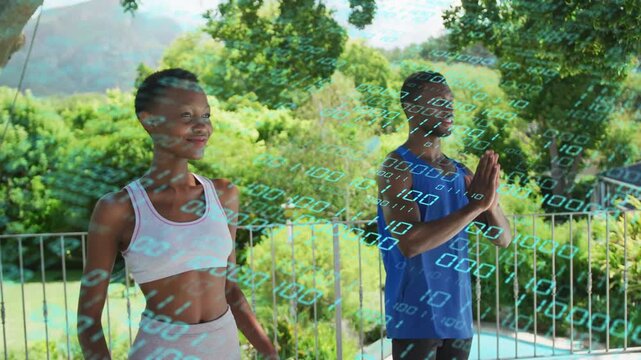 Two adults on balcony inhaling, raising hands into prayer for health, binary drifting across frame