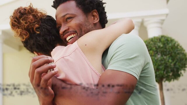 Couple hugging home entrance, tech glitch causing blue bars masking or revealing columns showing lov