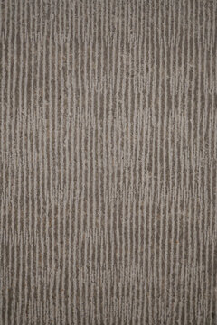 Modern textured stone surface with vertical linear grooves.