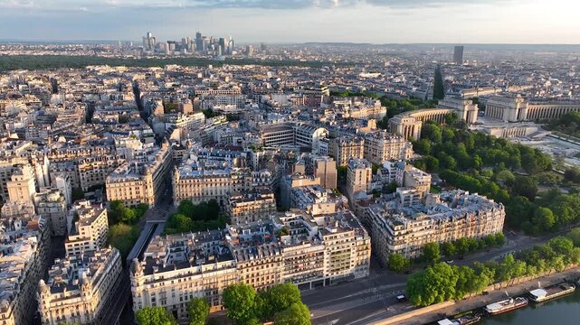 Aerial drone view of the sleepy streets of Paris, France, overlooking the famous Trocadero and Eiffel Tower at sunrise or sunset. Low motion over the rooftops. Cinematic 4k. Europe from above.