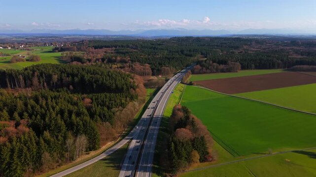 Aerial view of the A95 highway near Starnberg, Germany. The autobahn connects Munich and Garmisch-Partenkirchen, passing through the green Forstenrieder Park forest in Bavaria.