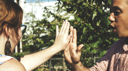 Obraz premium Playful Outdoor Hand Interaction: Celebrating Multiethnic Friendship and Communication in Nature