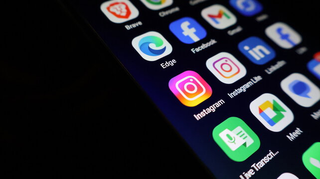 A smartphone screen displays various social media apps in a modern digital layout