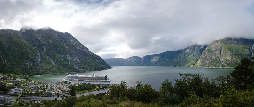 Eidfjord, Vestland, Norway 12.09.2024: Panorama view of the cruise ship Aida Perla in the fjord of the Norwegian town of Eidfjord with mountains in the background.