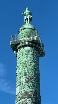 Celebratory bronze tower featuring relief sculptures and statue dome