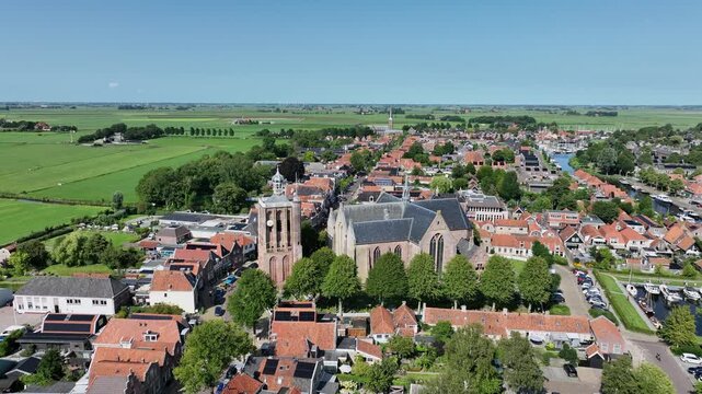 Historic canal town with prominent church tower in Europe