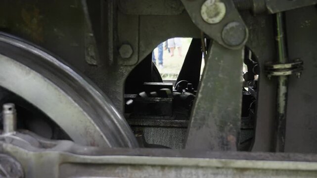 Close up of mechanical details, wheels and piston of a vintage steam engine. Historic locomotive, industrial heritage, 4K, ProRes, 50fps.