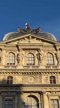 Urban filmmaker framing clock and statues cinematic golden facade