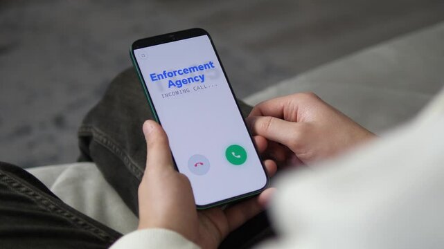 Smartphone screen showing an incoming call from Enforcement Agency. Person hesitating to answer a potential phone scam or phishing attempt. Perfect for cybersecurity, fraud prevention, and digital