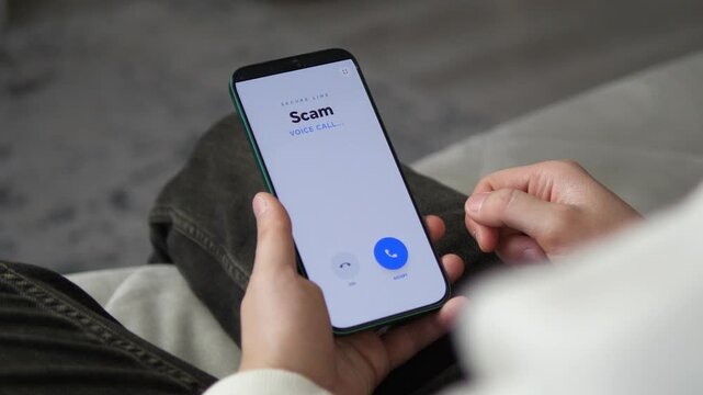 Smartphone screen displaying a Scam voice call notification. Great for bank security ads, telecom service commercials, and social engineering videos. High-quality UI design showcasing real-world cyber