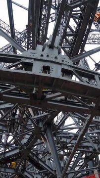 Eiffel tower steel lattice framework creating an abstract industrial pattern, highlighting the complex engineering and structural elements of the iconic monument