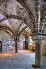 Fototapeta premium Mont Saint Michel Abbey, France, interior view. Low vaulted stone ceiling and massive pillars in medieval monastic hall