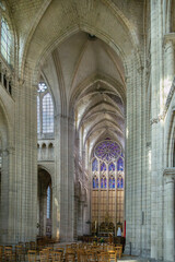 Fototapeta premium Soissons Cathedral, France, interior view. High gothic stone arches and vaulted ceiling in medieval church with soft light