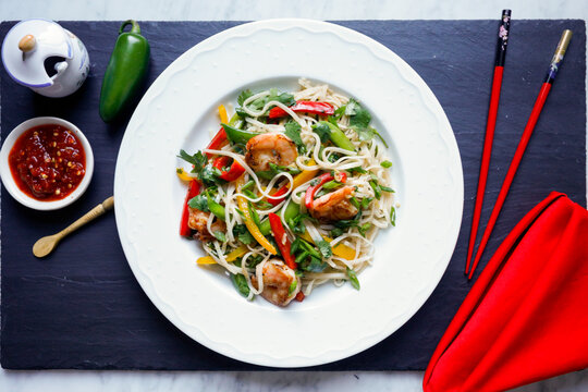 Asian shrimp noodle bowl with vegetables and herbs