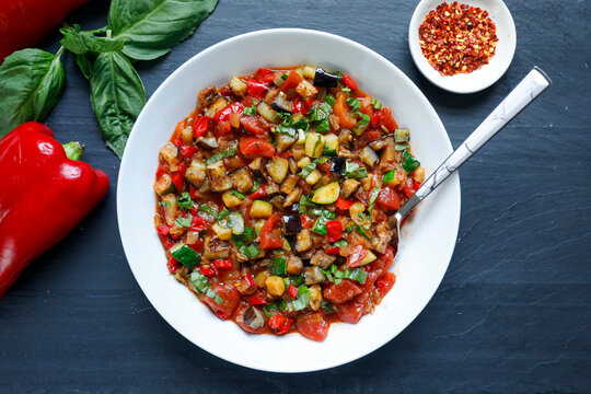 Ratatouille with roasted vegetables in white bowl