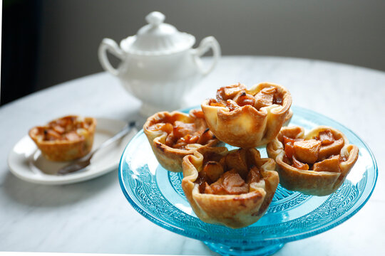 Mini apple tartlets on blue dessert plate